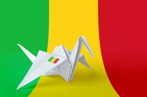 Mali flag depicted on paper origami crane wing. Handmade arts concept photo