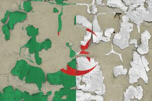 Algeria flag depicted in paint colors on old obsolete messy concrete wall closeup. Textured banner on rough background photo