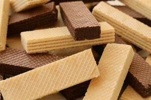 Stacked delicious chocolate wafers in large amount. Two different flavours of classic waffles photo