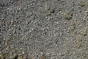 Background of shattered stony stones surface in mountain area. Texture with natural light photo