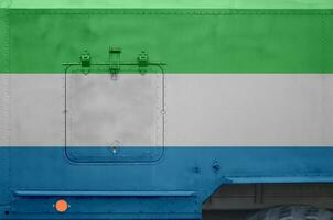 Sierra Leone flag depicted on side part of military armored truck closeup. Army forces conceptual background photo