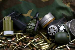 Different types of ammunition on a camouflage background. Preparing for war photo