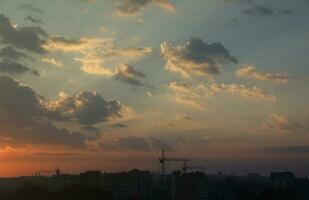 Beautiful sunrise with warm orange sunlight and beams through blue sky photo