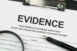 Evidence report blank on A4 tablet lies on office table with pen and magnifying glass photo