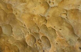 Combination of stone relief like a orange planet surface. Brown stone with abnormal relief shape photo