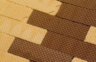 Stacked delicious chocolate wafers in large amount. Two different flavours of classic waffles photo