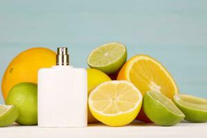 Perfume with citrus extracts. Selective focus. Spa day, concept of freshness perfume bottle with lemon lime and orange photo