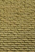 Texture of brick wall from relief stones under bright sunlight photo