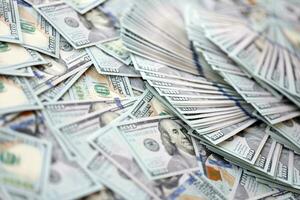 Very big amount of US hundred dollar bills. Huge quantity of united states currency notes on flat table photo
