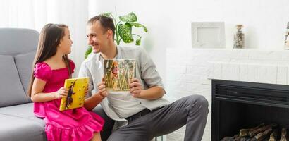 father and daughter hold photo canvas in the interior