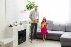 father and daughter hold photo canvas in the interior