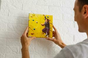 man holds canvas in the interior photo