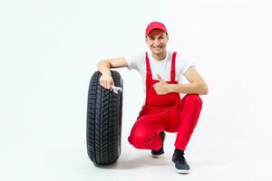 Mechanic holding a tire tire at the repair garage. replacement of winter and summer tires. photo