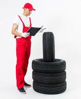 Mechanic holding a tire tire at the repair garage. replacement of winter and summer tires. photo