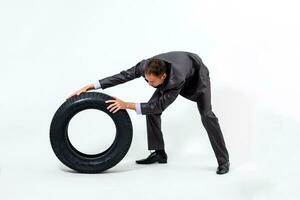 A serious businessman with car tires. Repair shop. Car service. Spare parts reselling. solated on white background photo