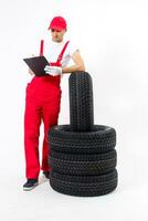 Young mechanic in uniform with a clipboard on white background photo