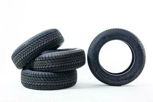 four black tires isolated on white background photo