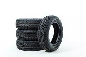 four black tires isolated on white background photo