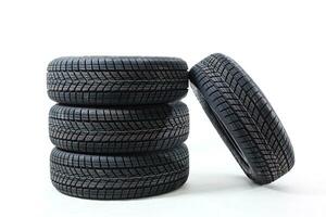 four black tires isolated on white background photo