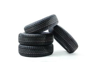 four black tires isolated on white background photo