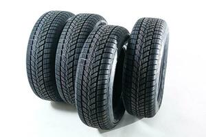 four black tires isolated on white background photo