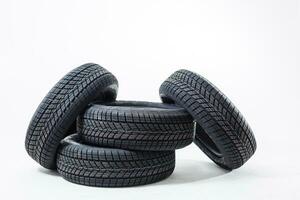 four black tires isolated on white background photo