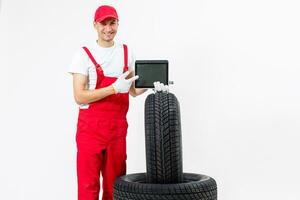 Young mechanic in uniform with a clipboard on white background photo