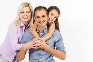 family and people concept - happy smiling mother, father and little daughter over white background photo