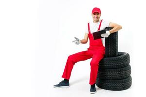 Young mechanic in uniform with a clipboard on white background photo