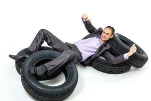 Car dealer man over tire tire background. Auto maintenance. photo