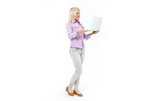 Smiling lovely stylish woman holding laptop computer while standing over white background photo