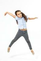 little girl jumps on a white background photo