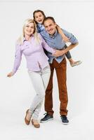 Portrait of young couple having fun with their daughter. Isolated on white background. photo