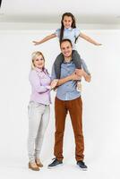 Portrait of young couple having fun with their daughter. Isolated on white background. photo