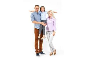 Happy young family with pretty child posing on white background photo