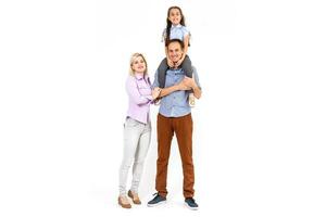 Happy young family with pretty child posing on white background photo