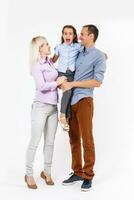 Happy young family with pretty child posing on white background photo