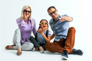 Frightened attractive family wearing casual outfit isolated over white background, watching a movie with 3d glasses photo