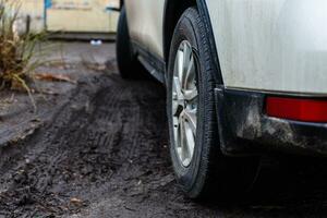 wheels of a white car in the mud photo