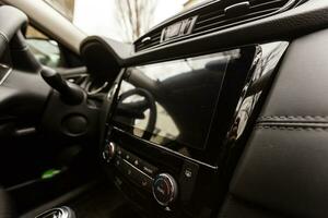 Car interior view with steering wheel and accessories photo