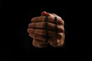 Man pray for something over the black background photo