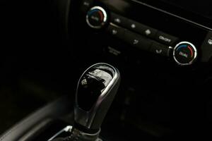 Gear shift handle in a modern car, closeup photo