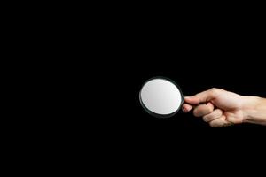 Magnifying glass on a black background photo