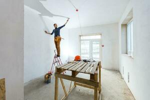 Mature contractor plasterer working indoors photo