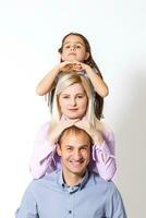 family and people concept - happy smiling mother, father and little daughter over white background photo