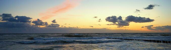 Baltic sea against dramatic cloudy sky at sunset photo