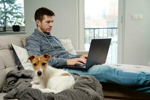 Man using laptop at living room photo