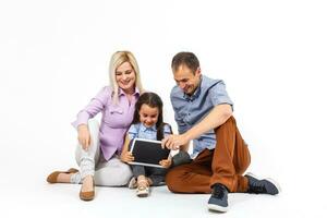 cheerful family using tablet computer isolated on white photo