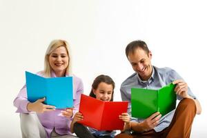 family with books together. Isolated on white background. photo