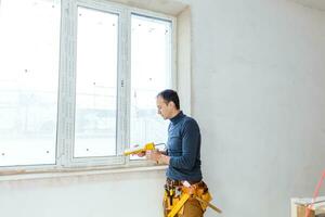 Worker in glazier's workshop, warehouse or storage handling glass photo